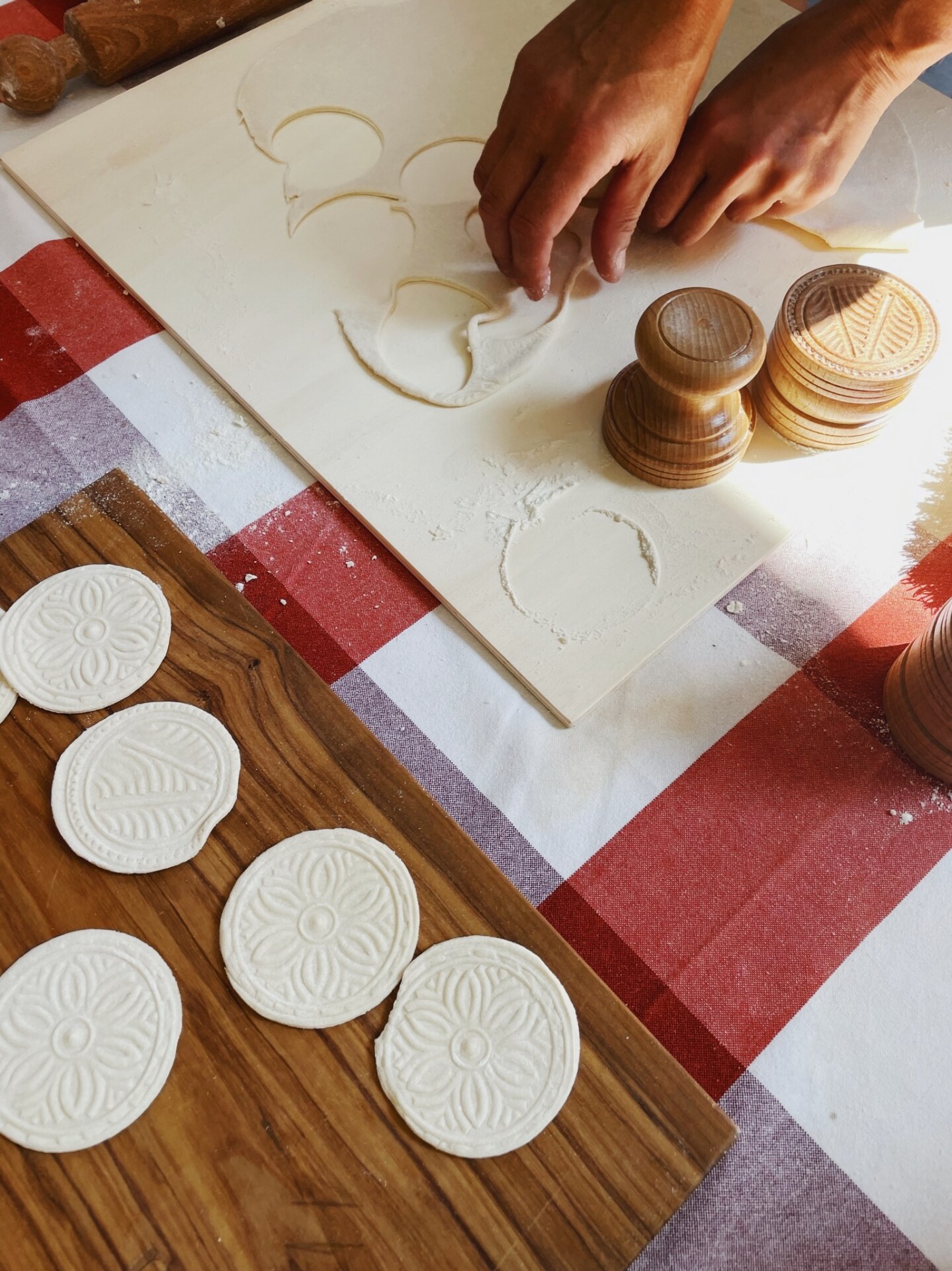 someone stamping out Corzetti pasta