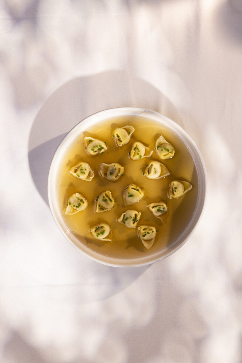 a bowl of tortellini in brodo