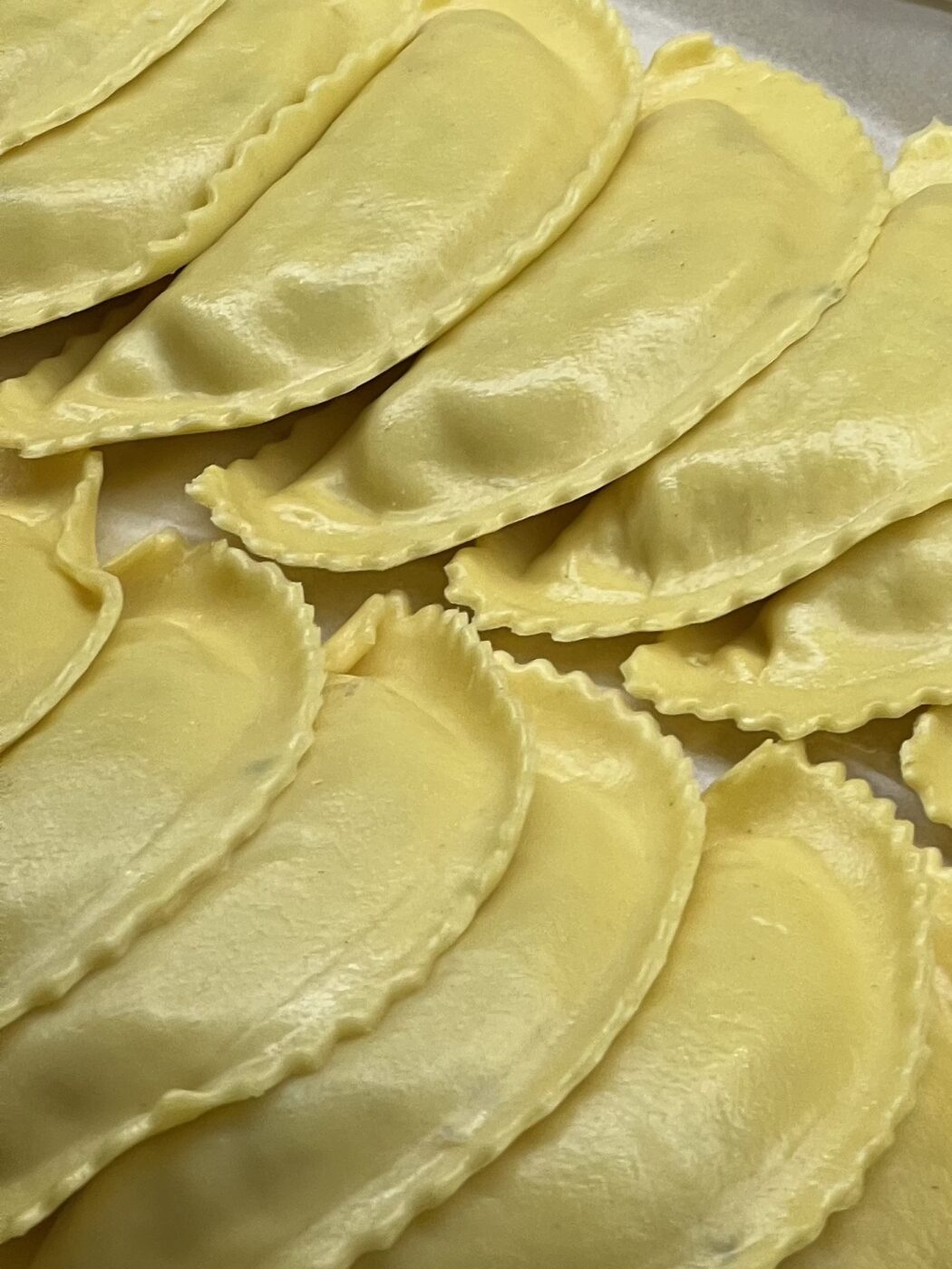 lots of half-moon-shaped ravioli layered on top of each other