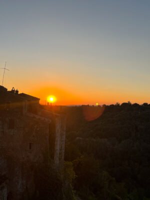 a view of the bright orange sunset over Pitigliano
