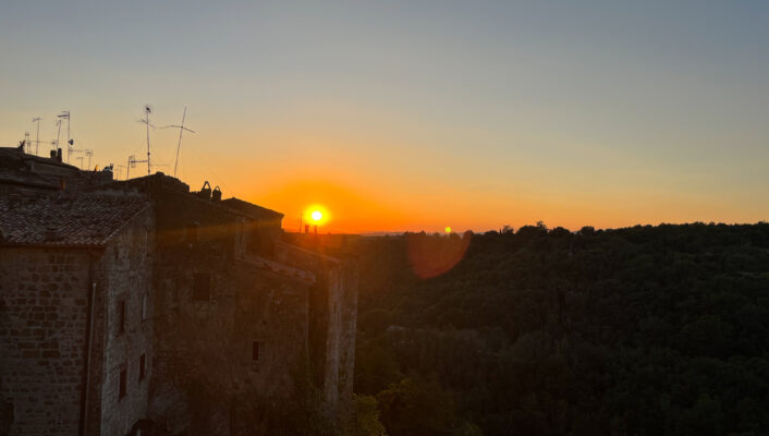 a view of the bright orange sunset over Pitigliano