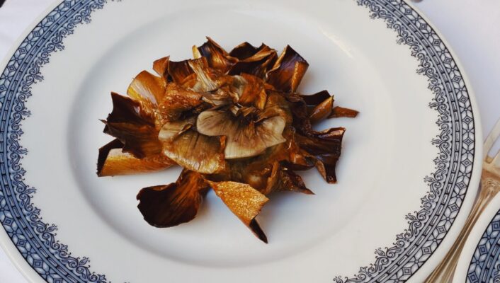 An image of fried carciofi alla giudia on a plate