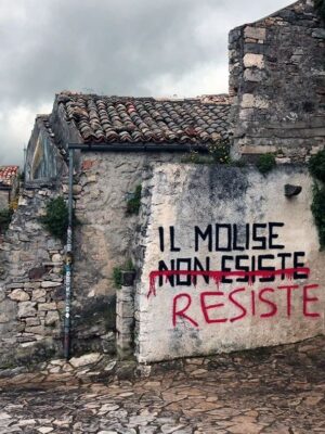 an image of street art in Molise that says "il molise non esiste" with the non esiste crossed out and replaced with "resiste"