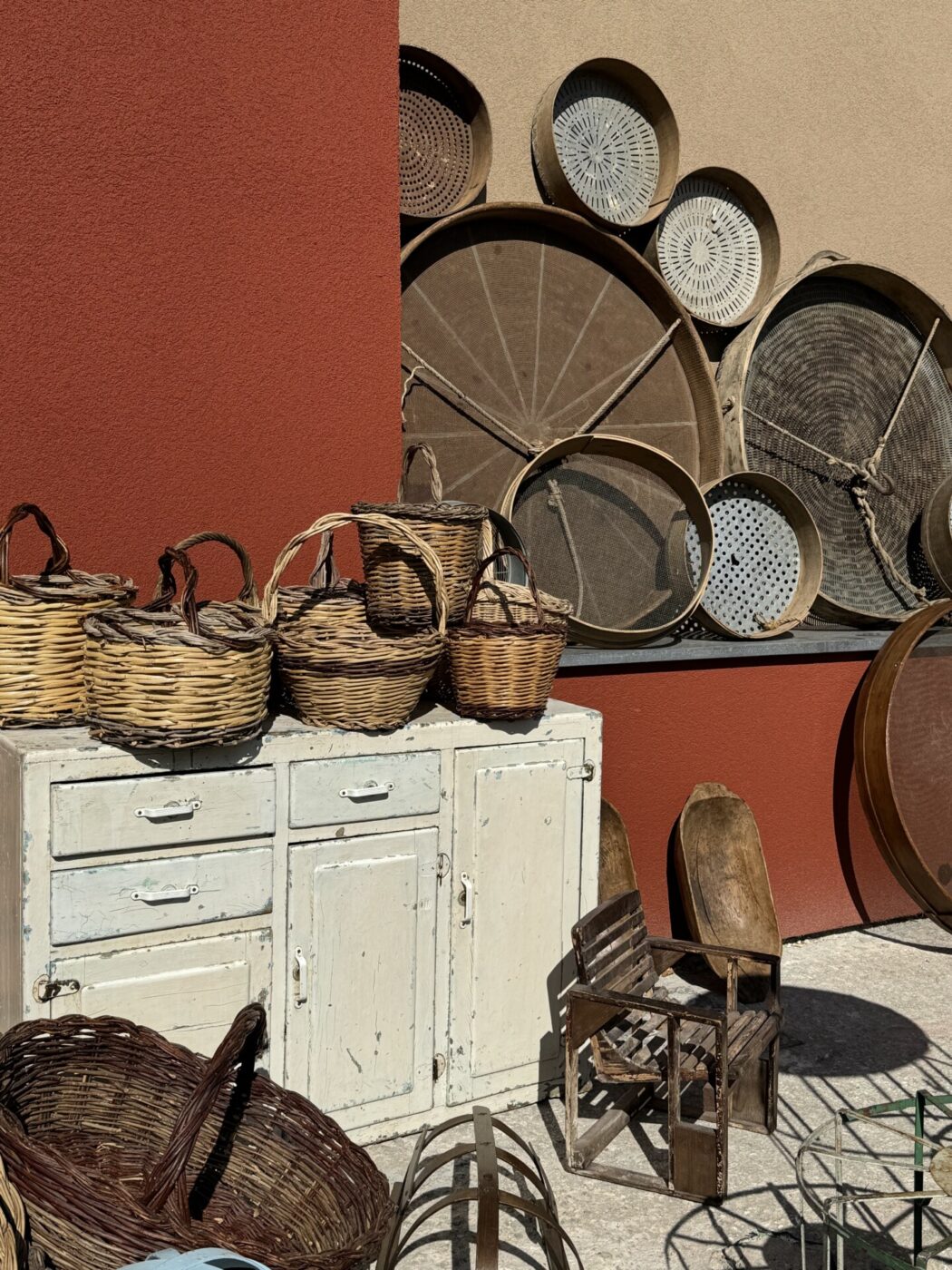 a collection of various baskets for sale at a market in Puglia