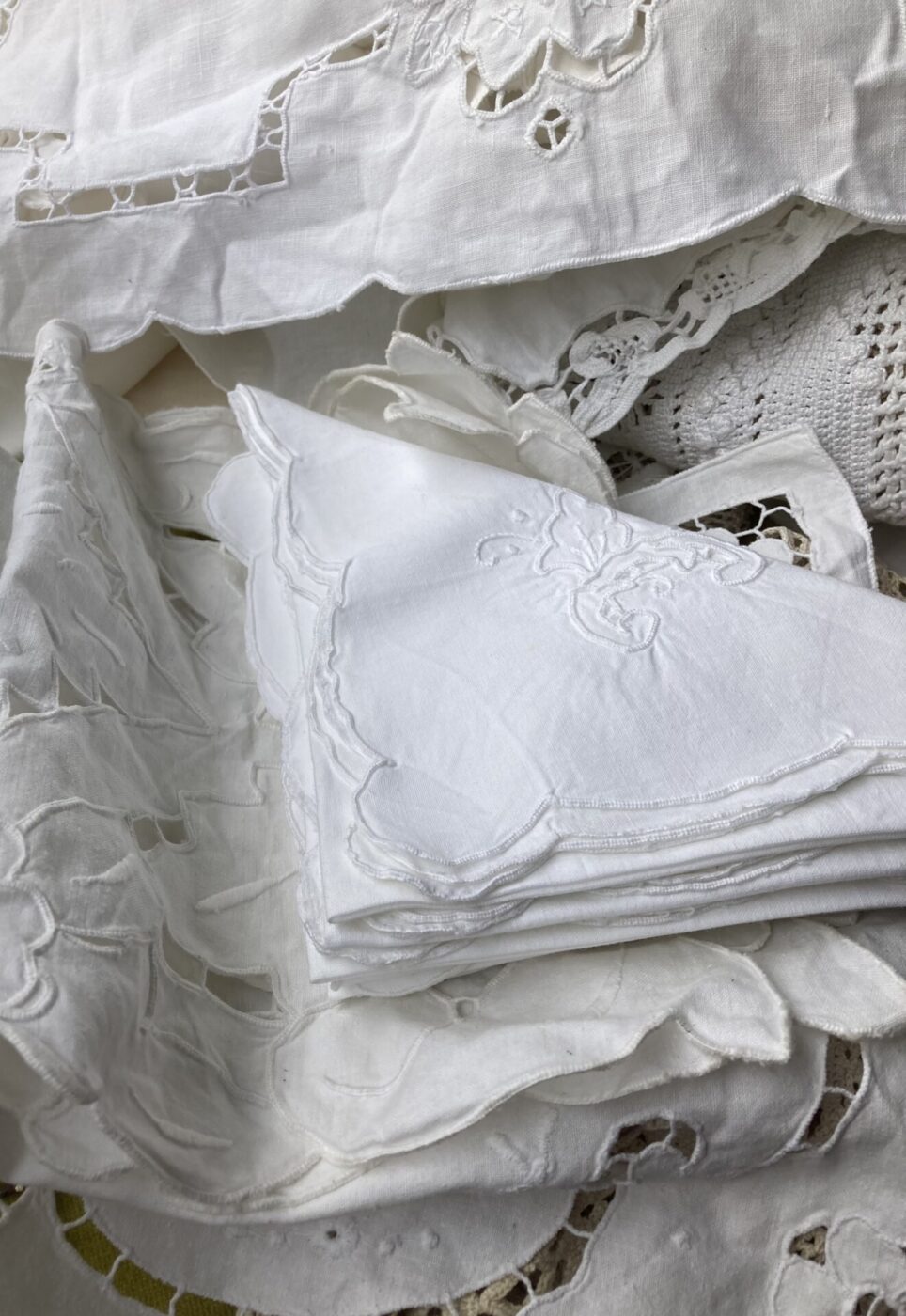 a collection of white napkins at a market in Puglia