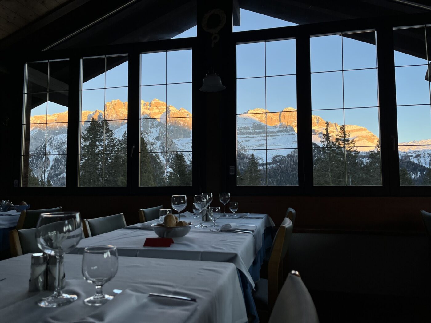 an image of the dolomites at sunset out the window of a rifugi in the dolomites
