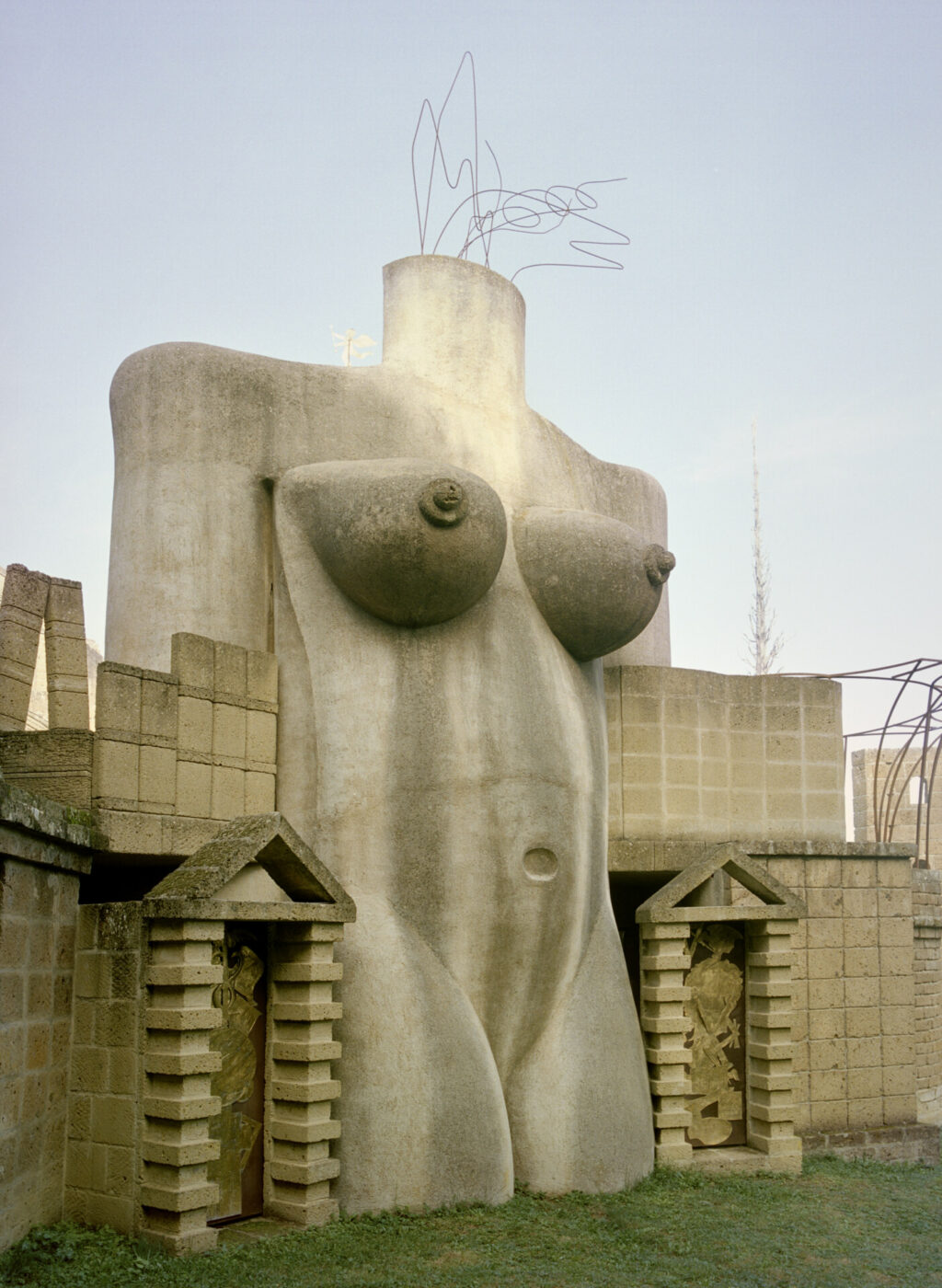 an image of a large statue of the mid region of a woman's body at La Scarzuola