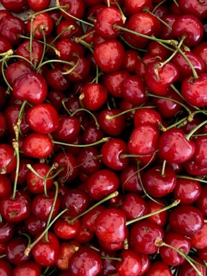 a close up image of a pile of bright red cherries