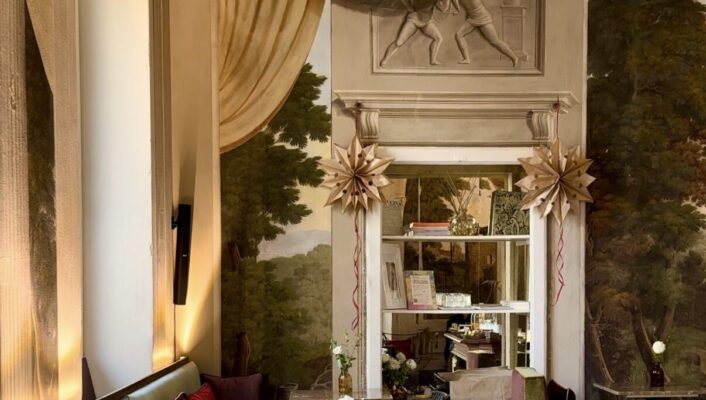 the interior breakfast area at stella d'italia with small tables along one long booth