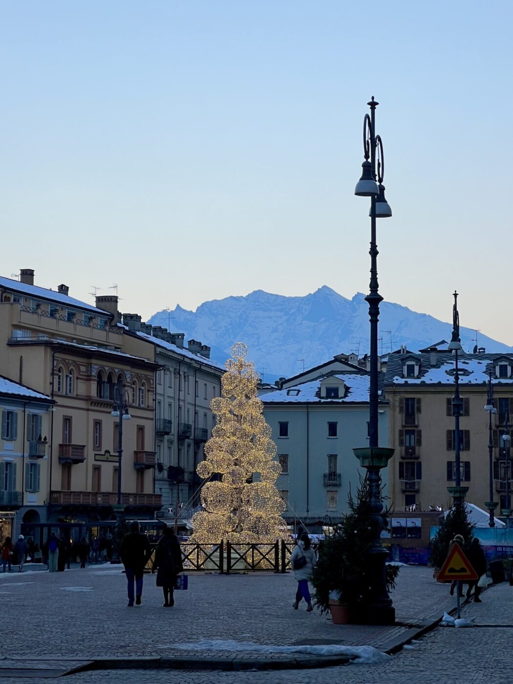 an image of the main piazza in aosta with a christmas tree made of lights