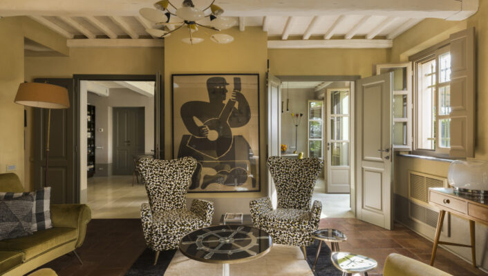 an iamge of two high backed black and white chairs in a seating room at Locanda Al Colle