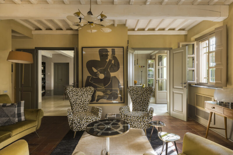 an iamge of two high backed black and white chairs in a seating room at Locanda Al Colle