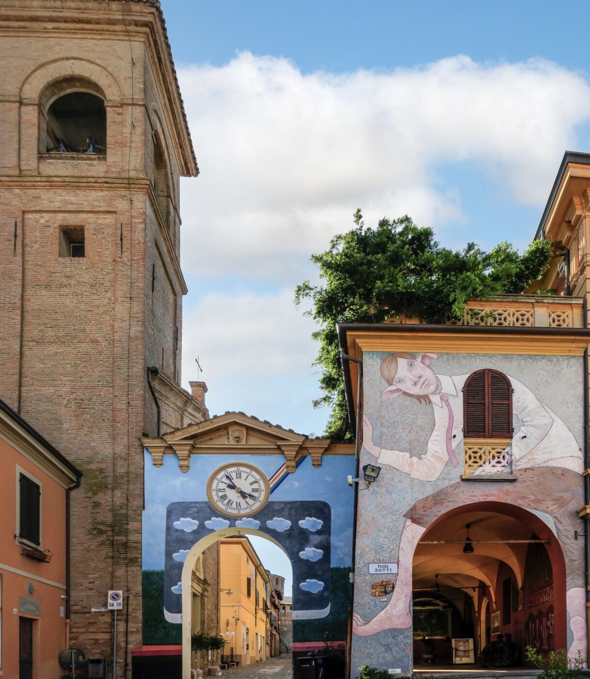 Dozza; an image of two archways, one painted with a cloud and a clock and one with an elf that looks like ron weasley