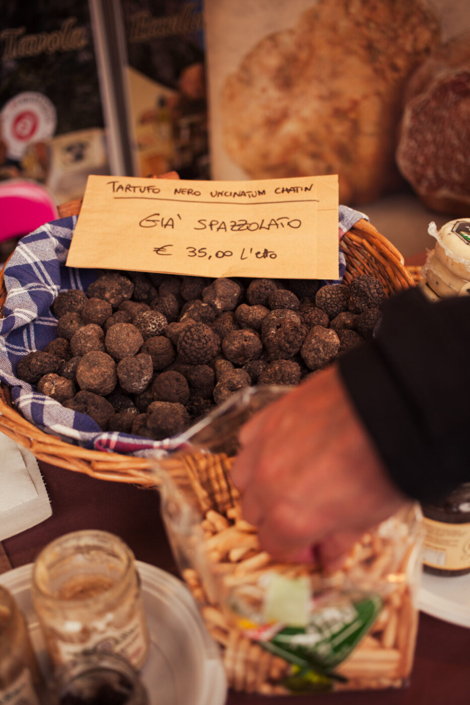 an image of a basket filled with truffles at a market in marche