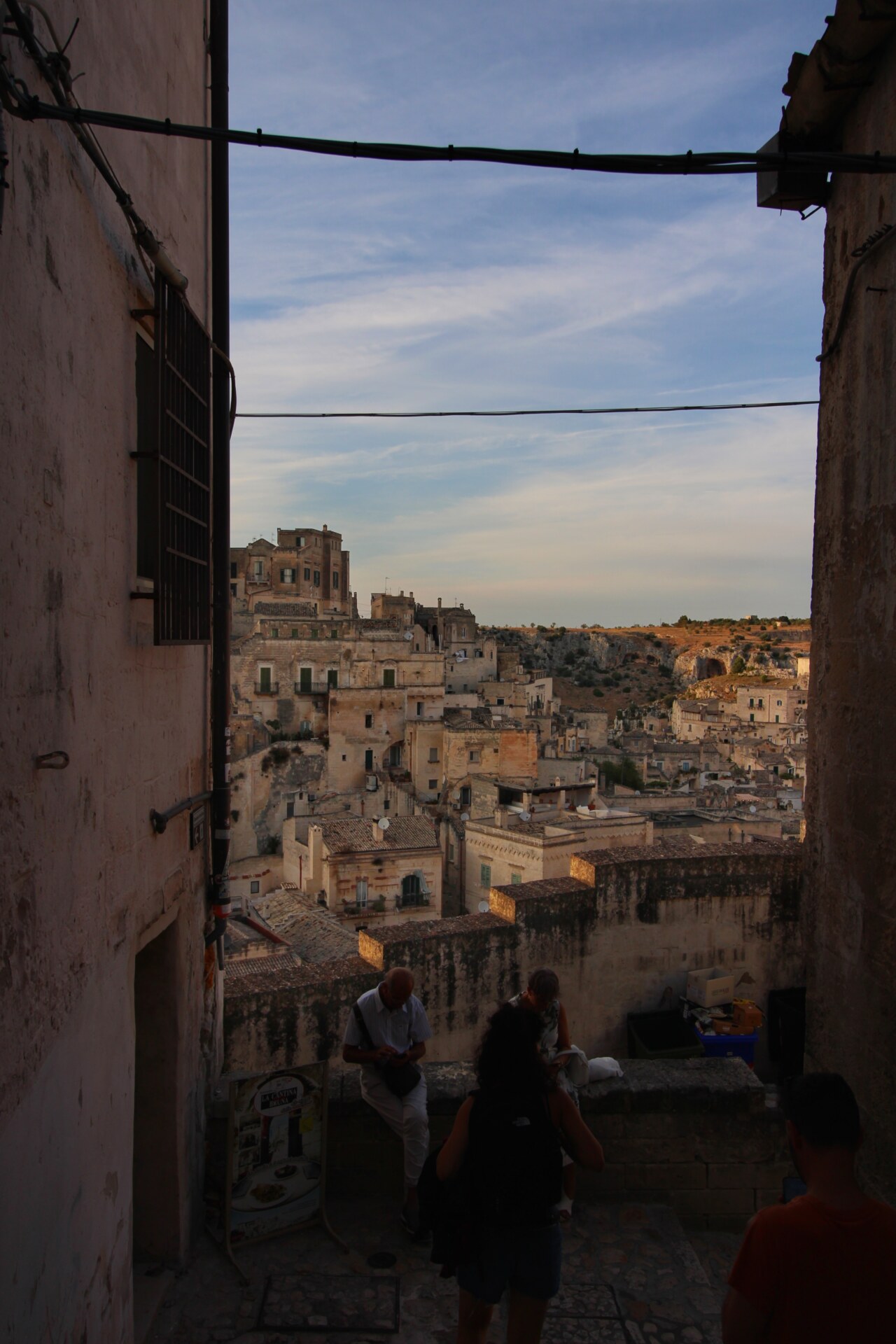 a darkly lit image of Matera taken from inside an alleyway