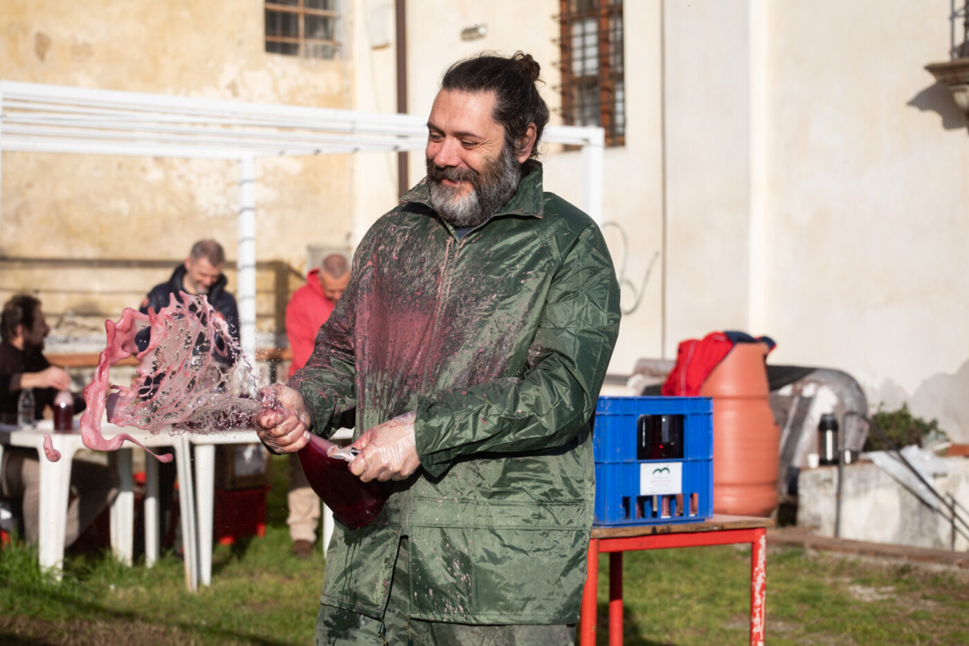 an image of a man from VUM exploding a bottle of wine