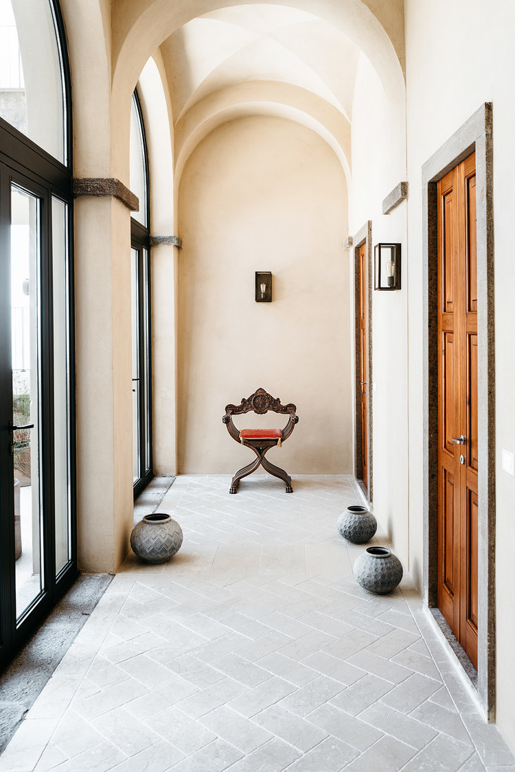 a hallway at Forte San Giorgio with a small stool at the end