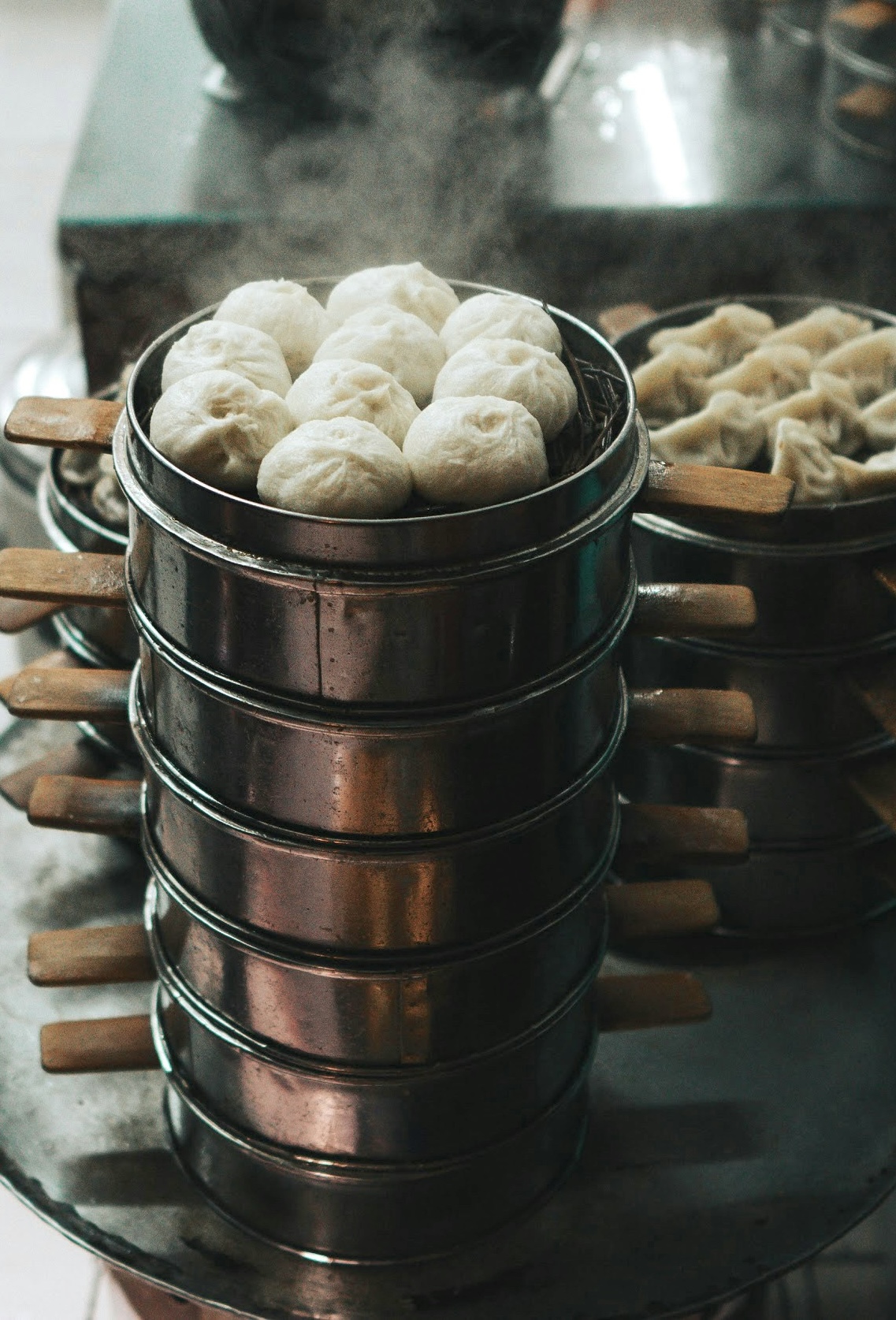 a tall tower of steaming dumplings