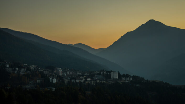 the beautiful colors of the autumn in the italian alps during sunset over Oulx