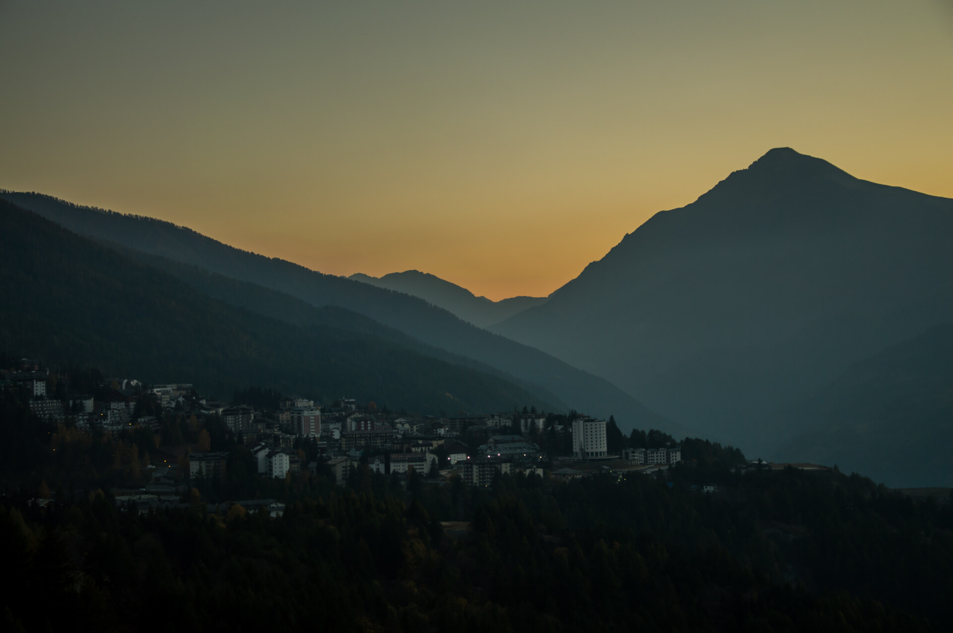 the beautiful colors of the autumn in the italian alps during sunset over Oulx