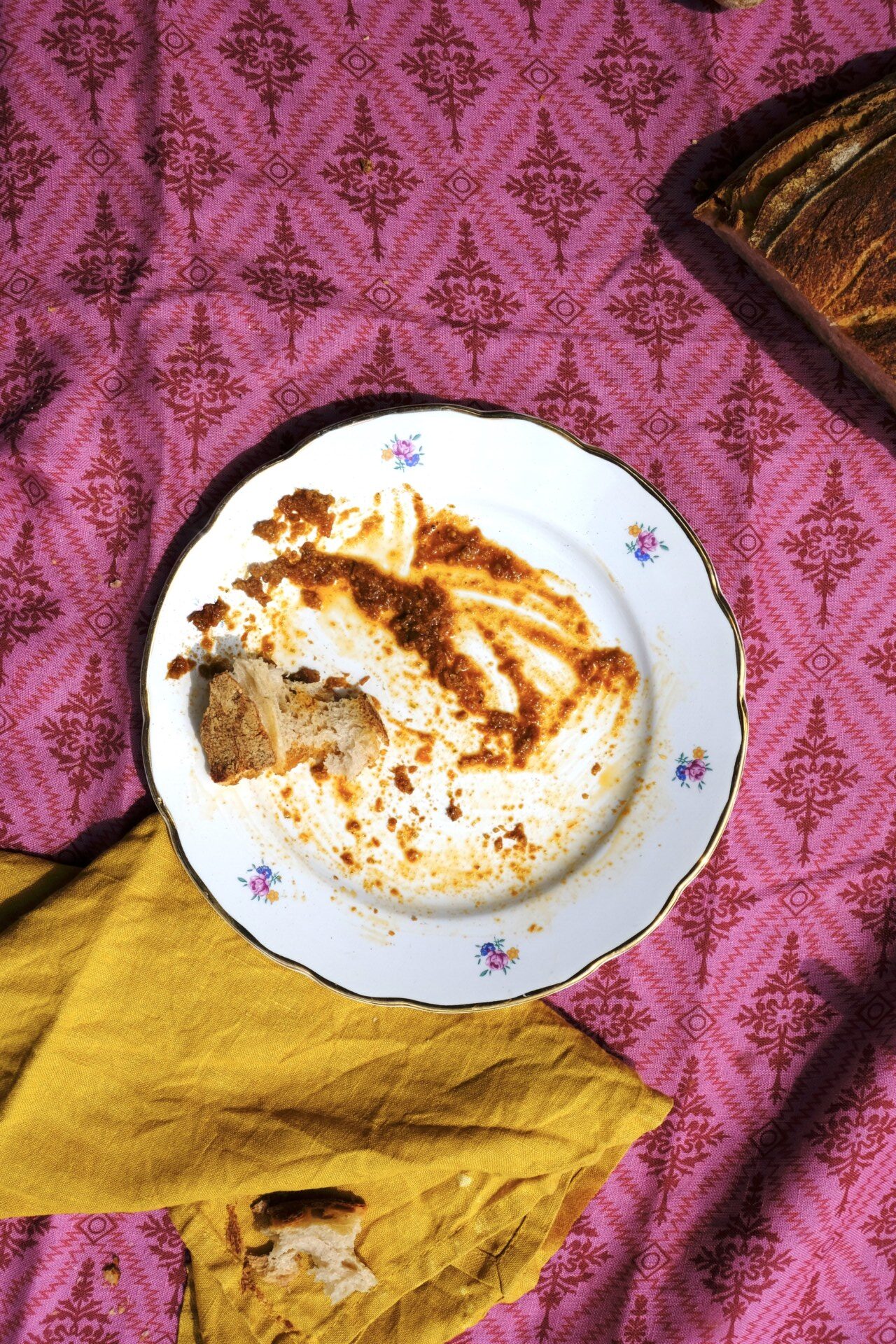 an overhead photo of a plate for scarpetta on a hot pink tablecloth