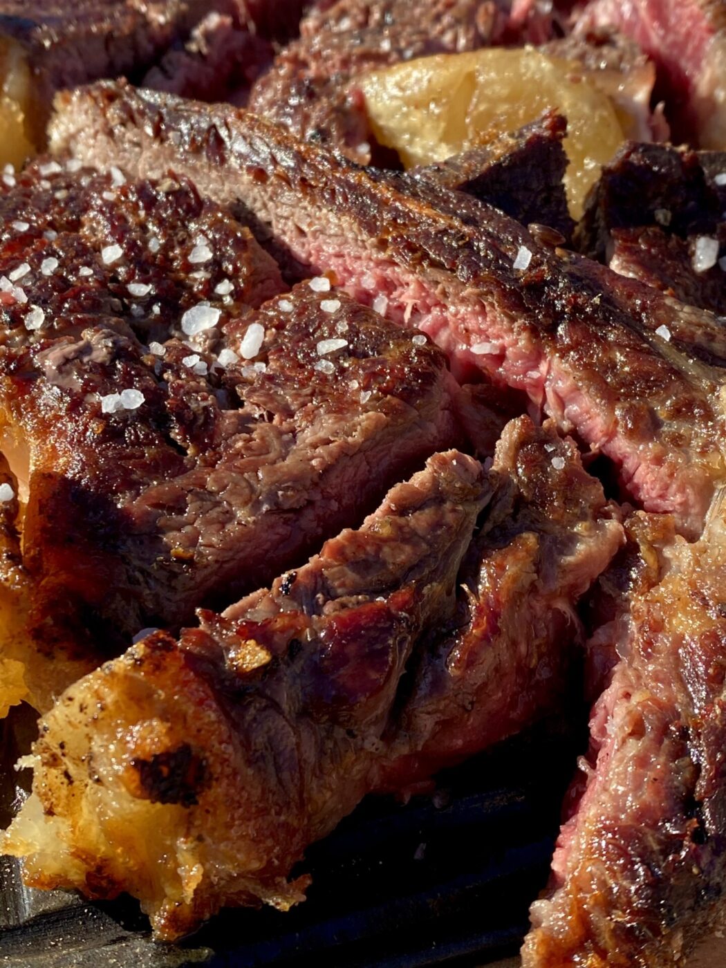 a close up of bistecca fiorentina with salt flakes on top