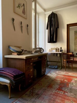 Atelier Bomba the interior tailoring space with a coat hanging in the distance