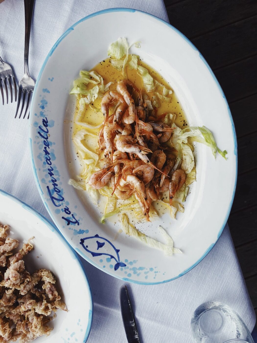 an overhead image of a plate of shrimp and cabbage at La Tonnarella