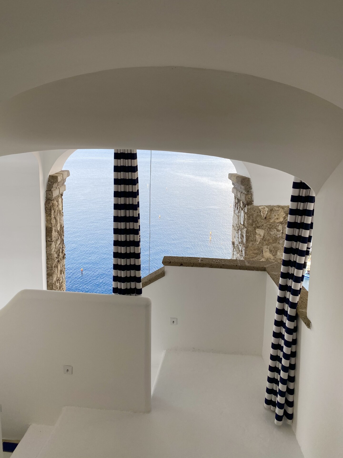 the white stairs out of a room down to the sea at La Minervetta