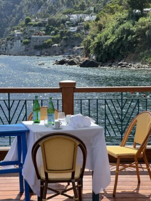 a table at a cafe in the amalfi coast overlooking the sea