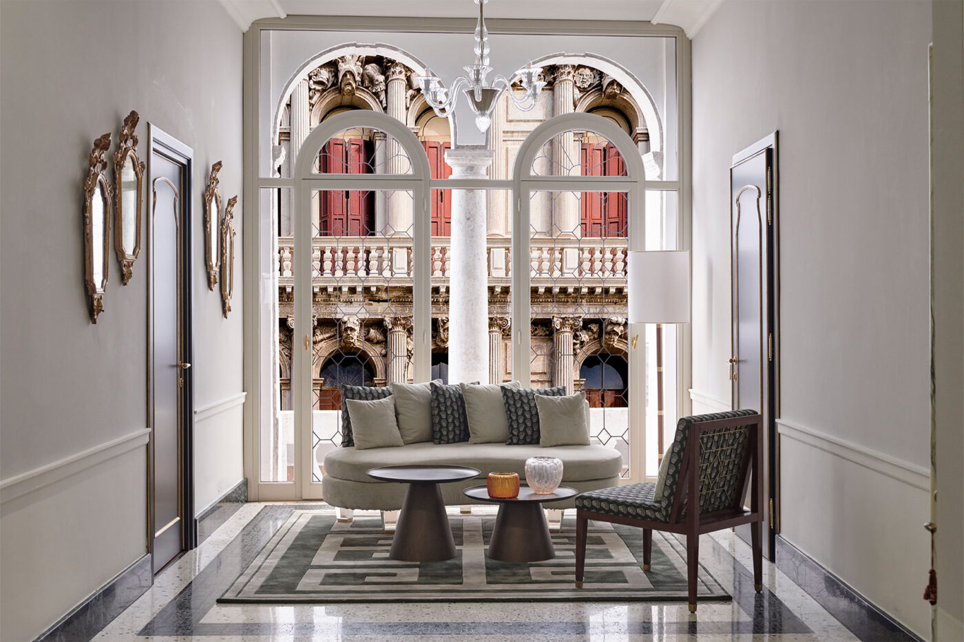 a couch against large windows at violino d'oro overlooking the venice canals