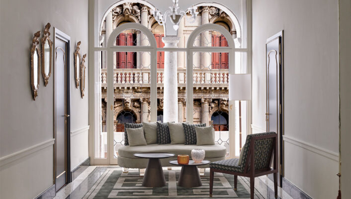 a couch against large windows at violino d'oro overlooking the venice canals