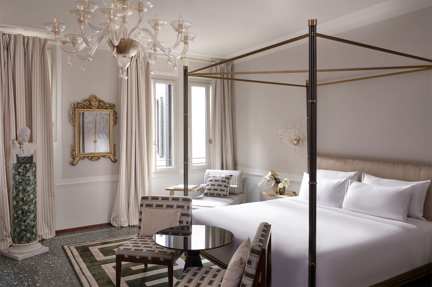 a room at violino d'oro with a framed bed and mirrored table