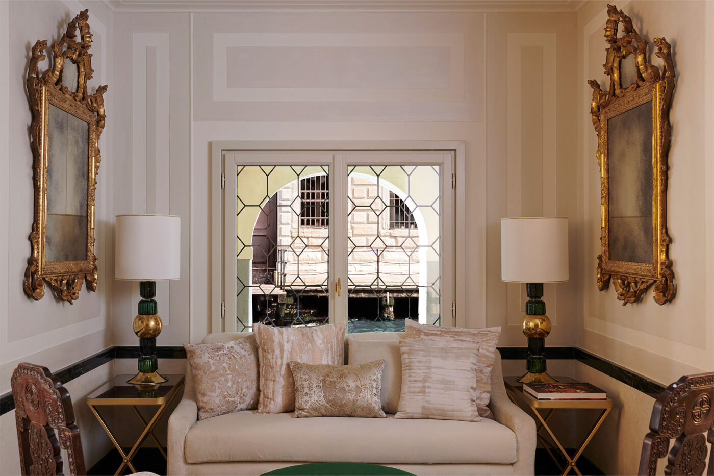 a room at violino d'oro with a couch and a window overlooking the canal