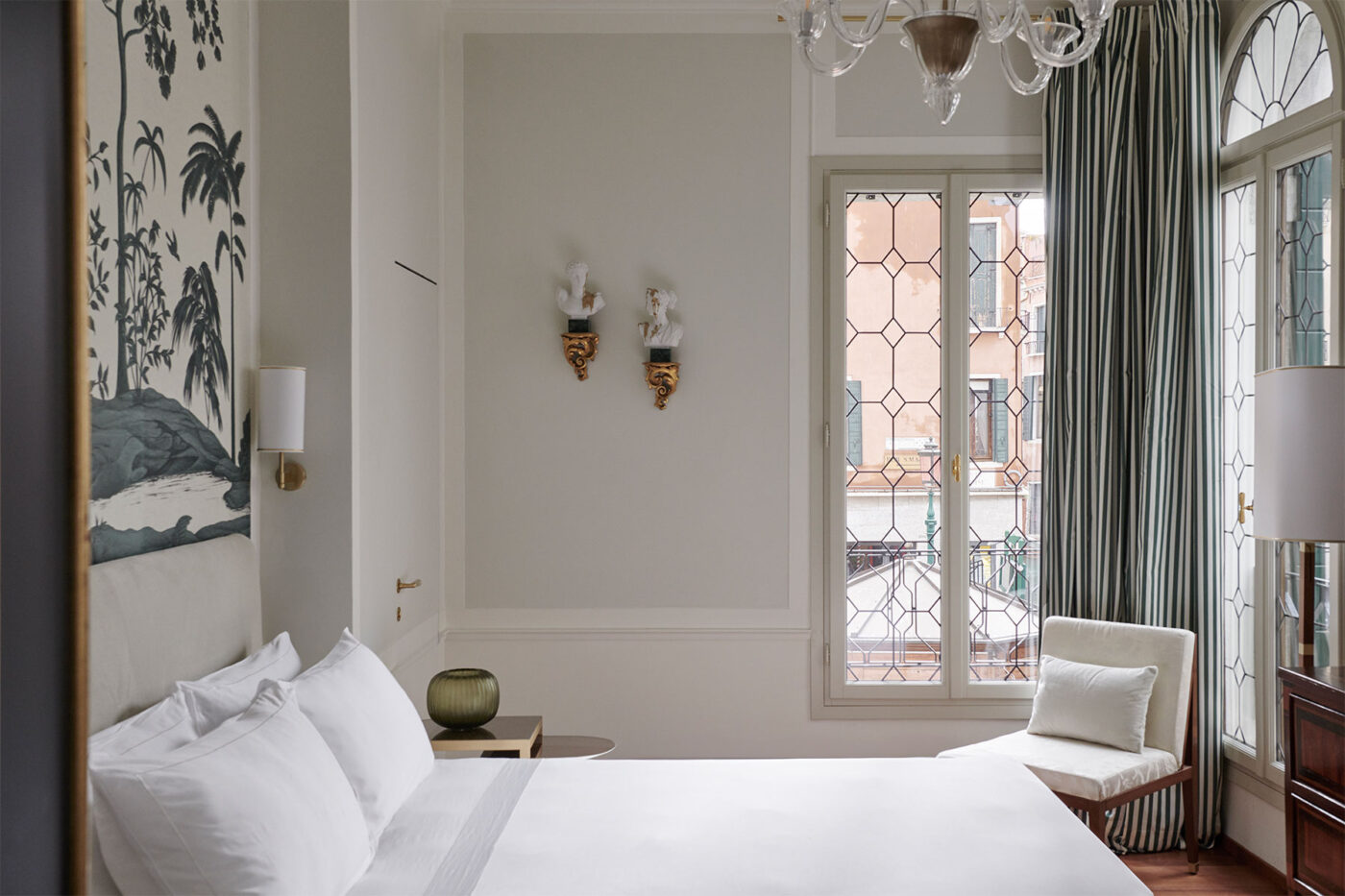 a white, brightly lit bedroom at violino d'oro