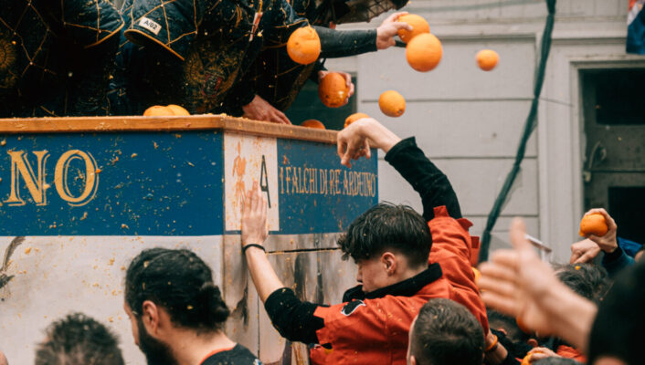 an action shot of orange throwers on the carriage hurling oranges down