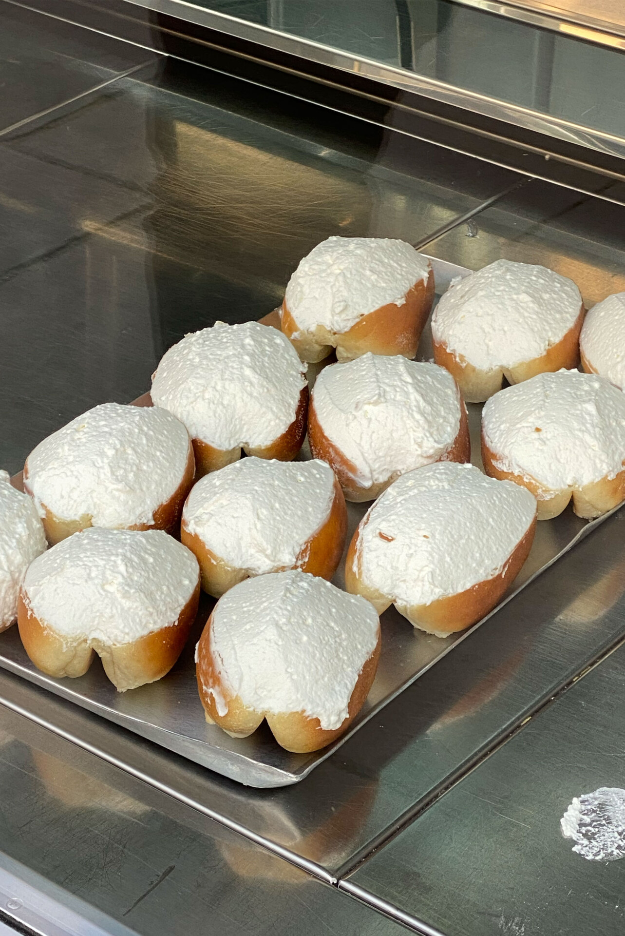 a tray of maritozzi at Pasticceria Regoli