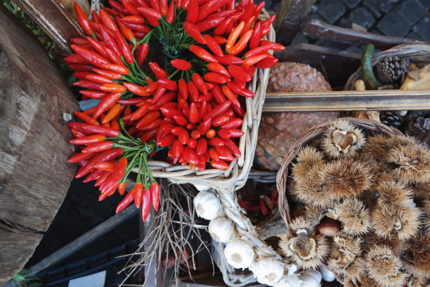 an image of red chili peppers and garlic and nuts at a market in Rome