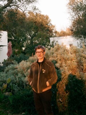 an image of Cosimo Terlizzi standing in the yard by his house in Puglia at golden hour