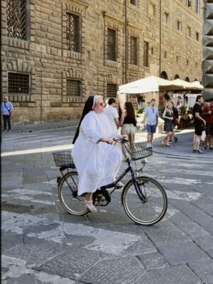 an image of a nun riding a bike