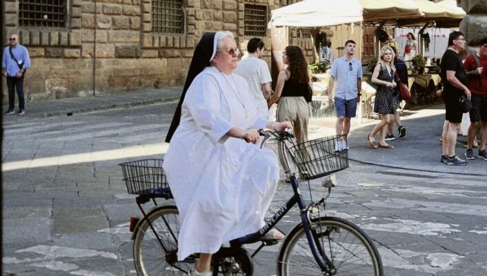 an image of a nun riding a bike