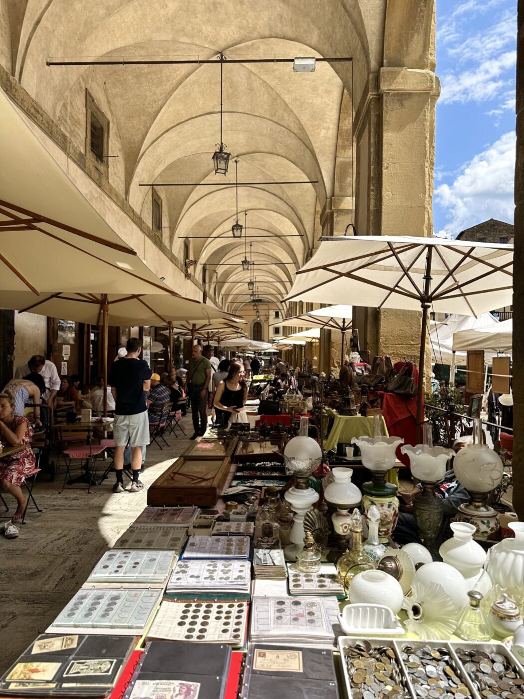 in image of rows of vintage products underneath the porticos in Tuscany