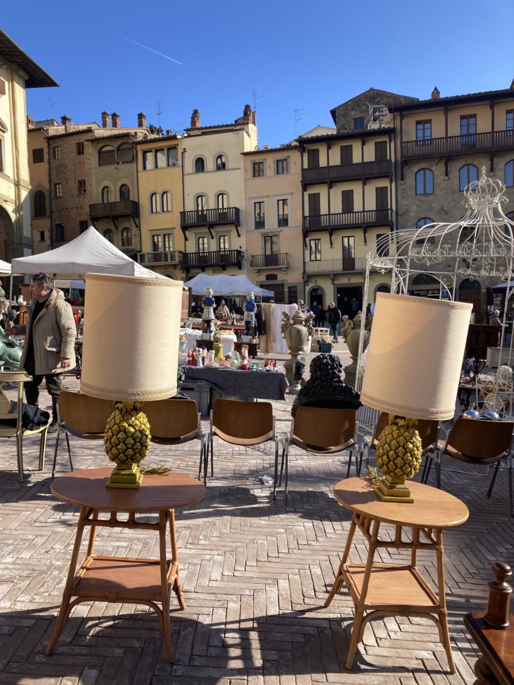 a piazza filled with things at a Vintage Market in Tuscany