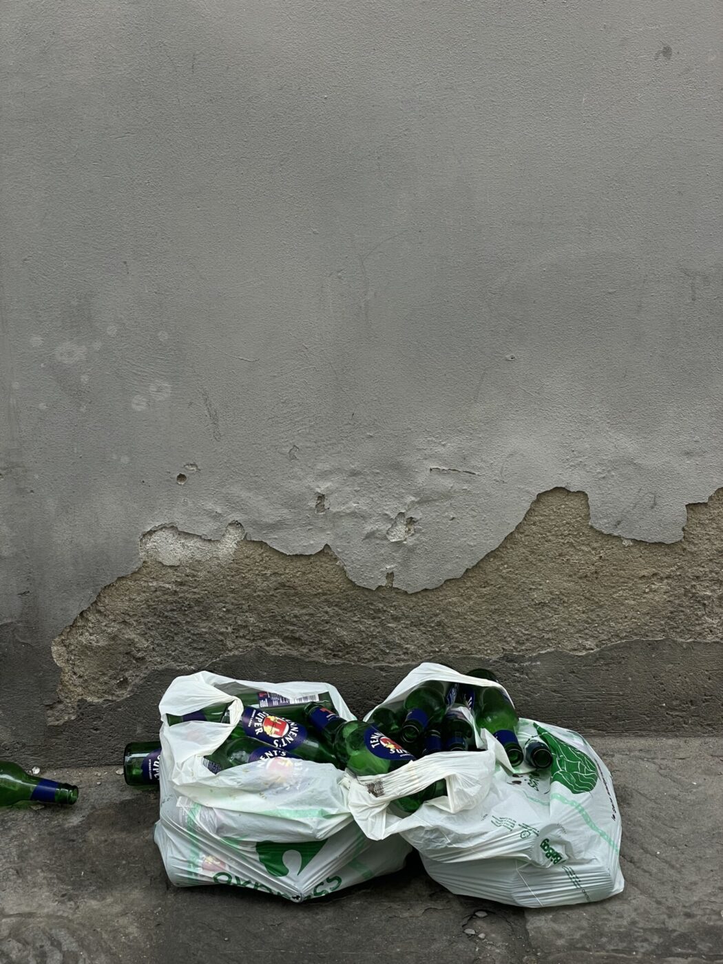 an image of trash bags filled with empty beer bottles sitting on the ground