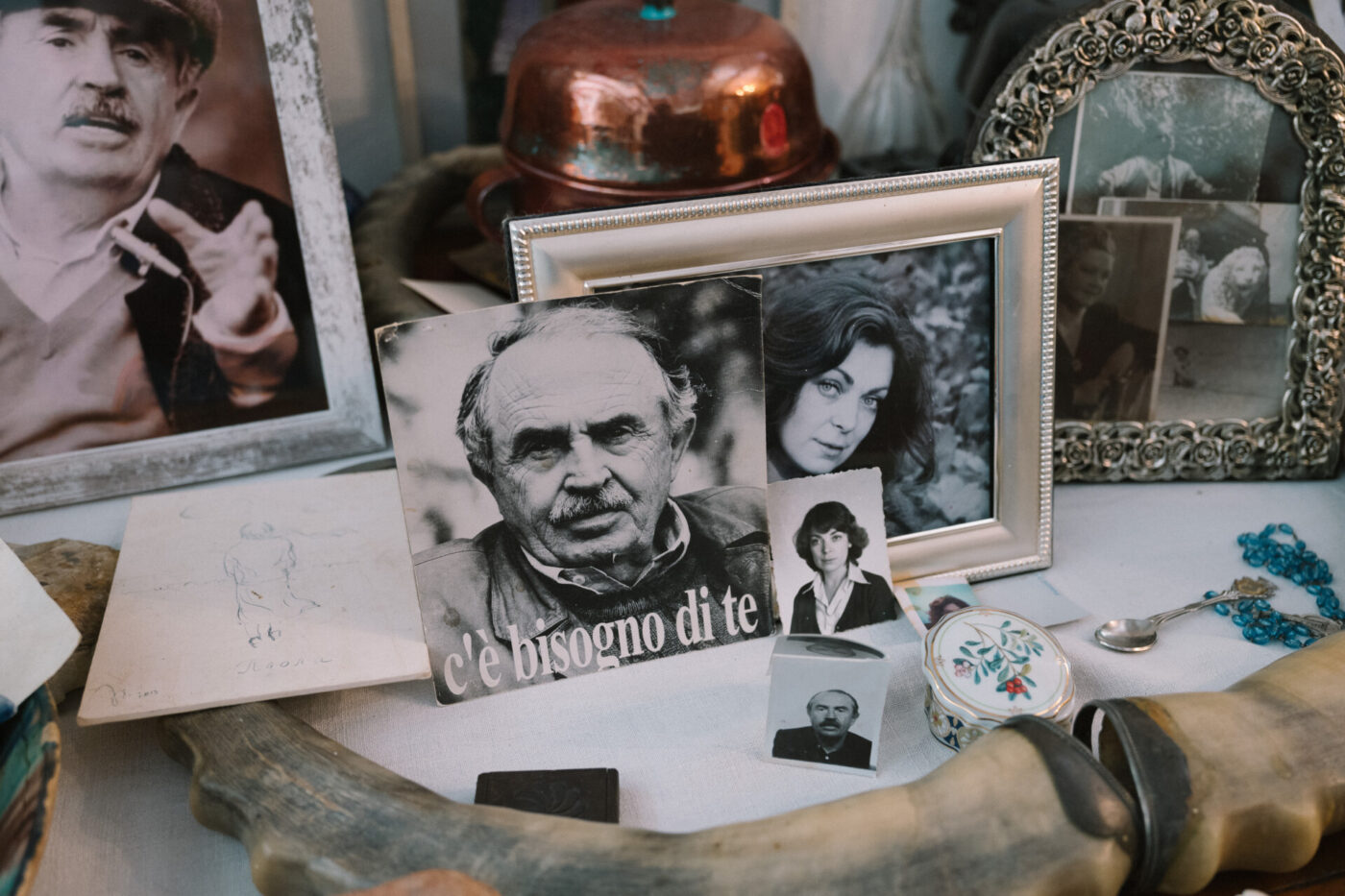 black and white photos and frames cluttering a table