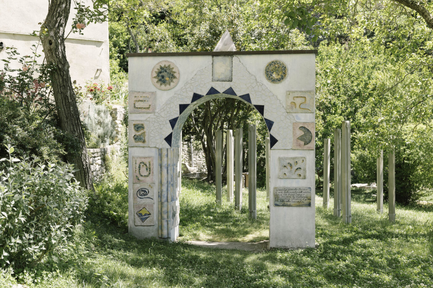 a white arch in the forrest