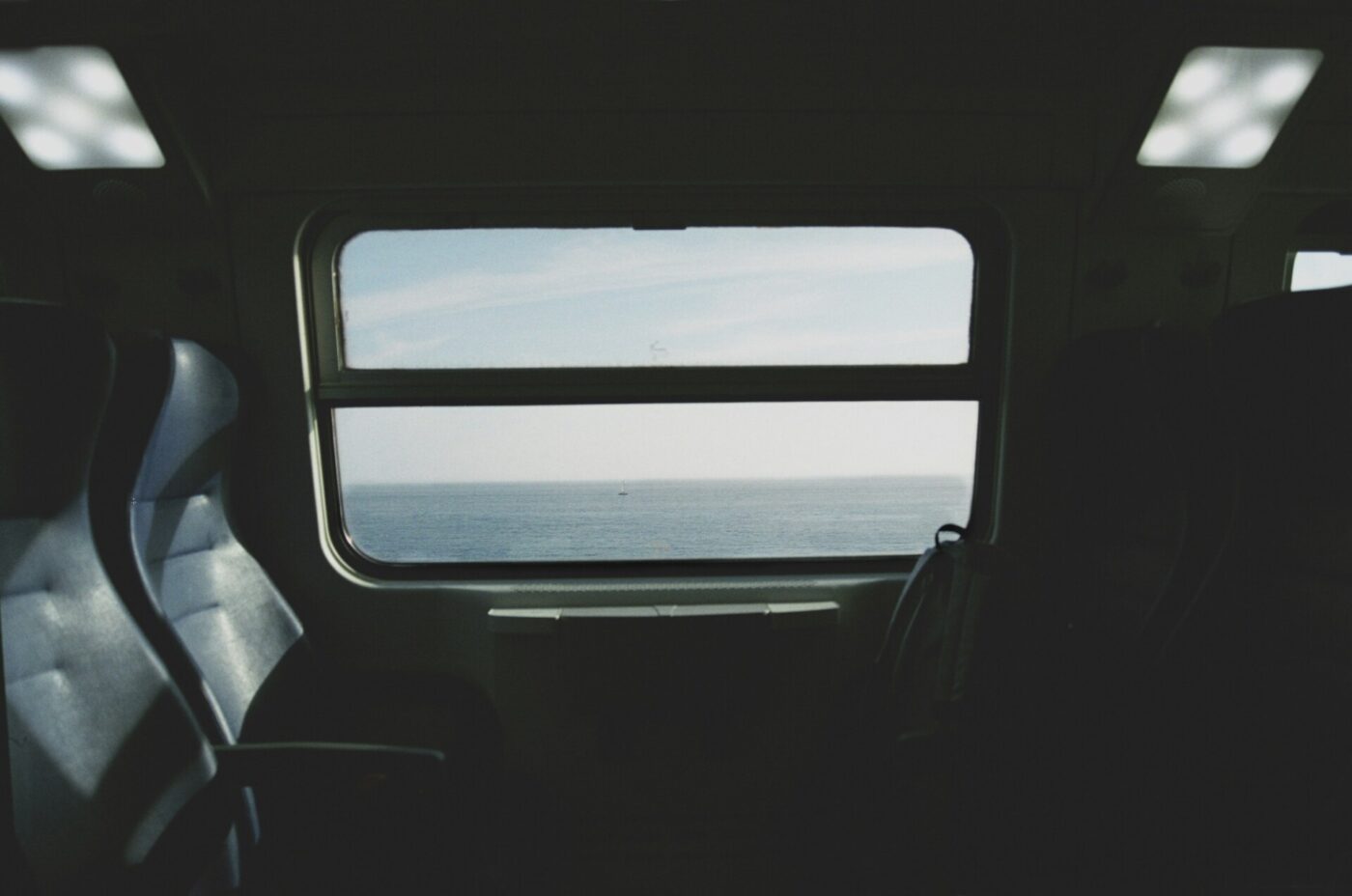 an image of the sea out of a train window