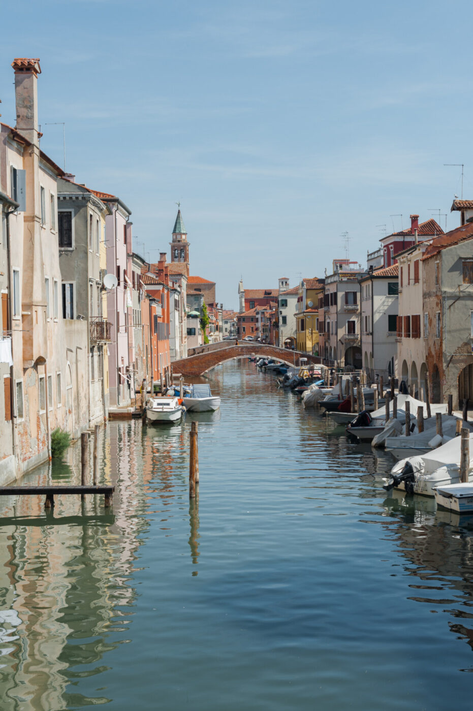 the canal in Chioggia lined with boats and covered with bridges