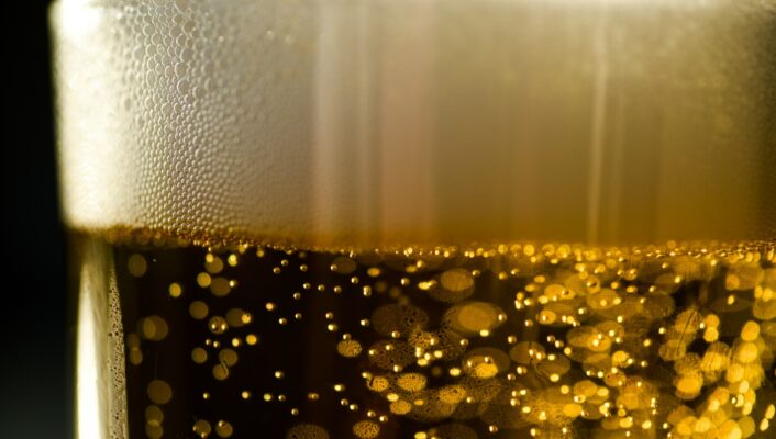 a closeup of the thin layer of foam on top of bubbly beer