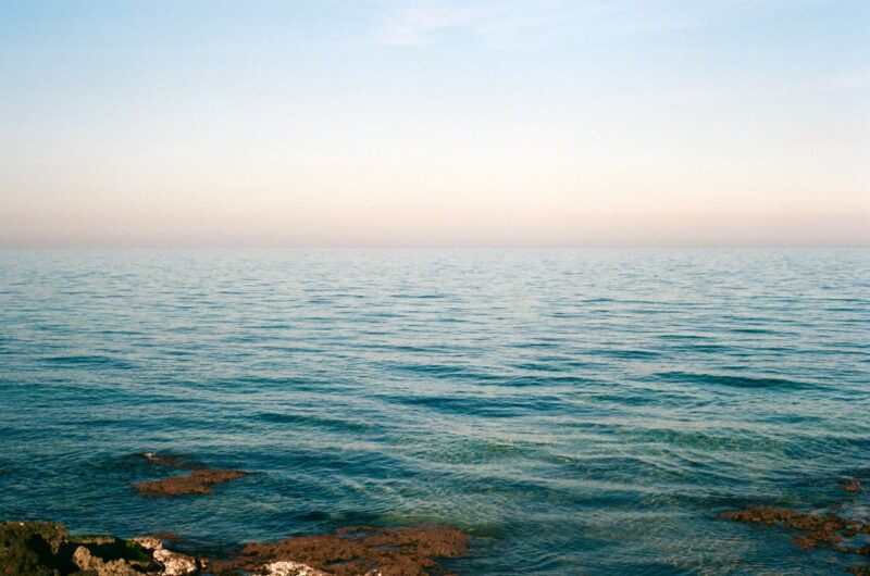 a film photo of sunset over the turquoise waters of Puglia